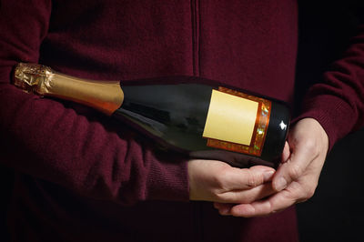 Midsection of man holding book