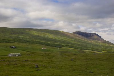 Scenic view of green landscape against sky