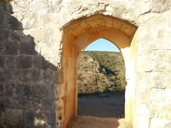 Arch bridge over stone wall