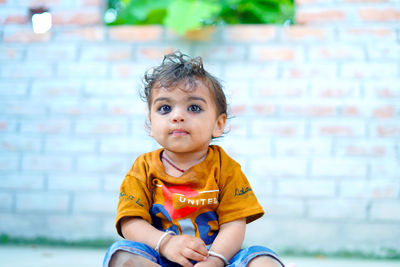 Portrait of cute boy sitting on chair