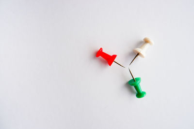 High angle view of multi colored paper on white background