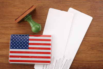 High angle view of american flag with labels on wooden table