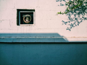 Low angle view of window on wall of old building