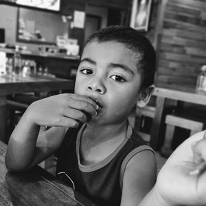 Portrait of boy sitting in restaurant