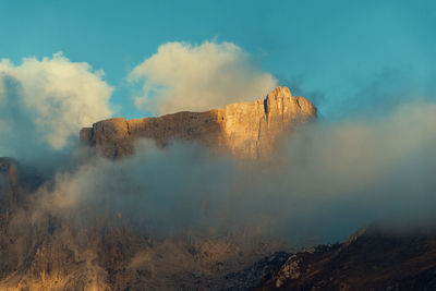 Clouds and mountain against sky