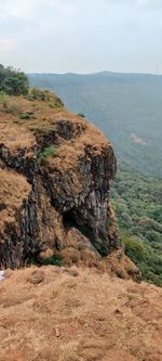 Scenic view of rocks on land against sky