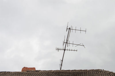 Low angle view of communications tower against sky