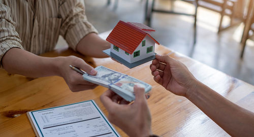 High angle view of woman using smart phone on table