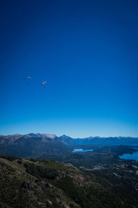 Scenic view of mountains against blue sky