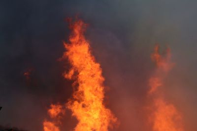 Low angle view of fire against sky at night