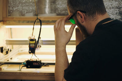 Laser burning on various materials. cropped view of the man worker burning with laser machine on