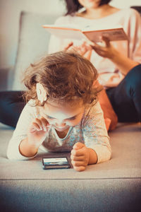 Full length of girl using mobile phone