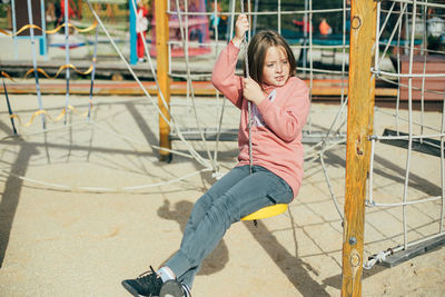 Smiling girl sitting at playground