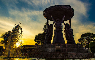 Statue of temple against sky during sunset