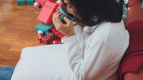 High angle view of woman using mobile phone at home