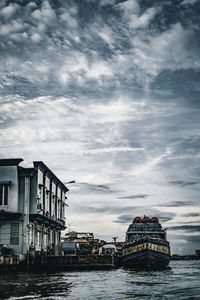 Scenic view of sea by buildings against sky