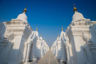 Panoramic view of statues outside building against clear sky