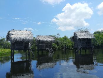 Built structure by lake against sky