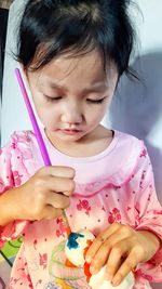 Close-up of cute girl holding pink