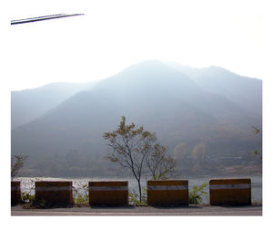 Scenic view of mountains in foggy weather