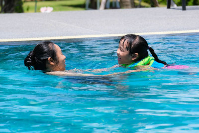 Young woman swimming in pool