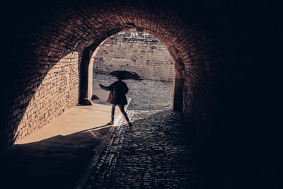 Woman standing in tunnel