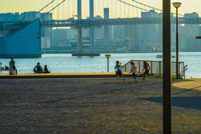 Rear view of people walking on promenade