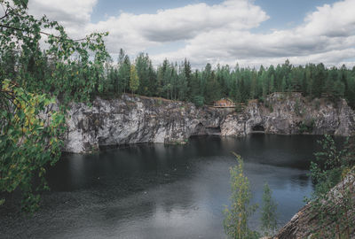 Scenic view of river in forest against sky