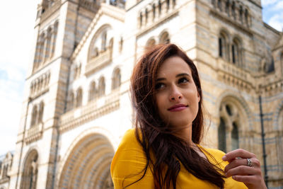 Beautiful woman looking away in city