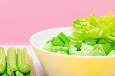 Close-up of green leaves in bowl on table