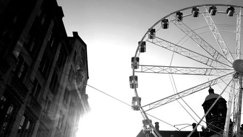 Low angle view of ferris wheel against sky