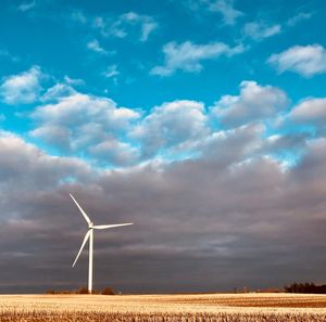 Windmill on field against sky