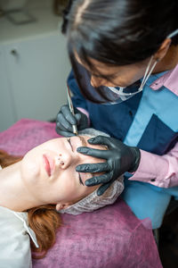 Close-up of doctor examining patient at home