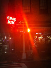 Illuminated road sign at night