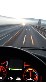 Cropped image of car moving on road