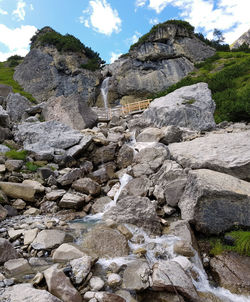Low angle view of rocks on shore against sky