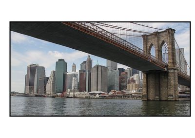 Bridge over river in city against sky