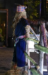 Rear view of woman standing against wall