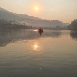 Scenic view of lake against sky during sunset