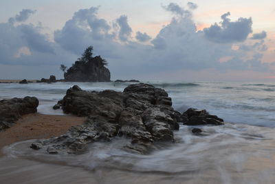 Scenic view of sea against cloudy sky during sunset