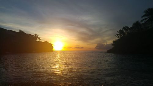 View of sea against cloudy sky during sunset