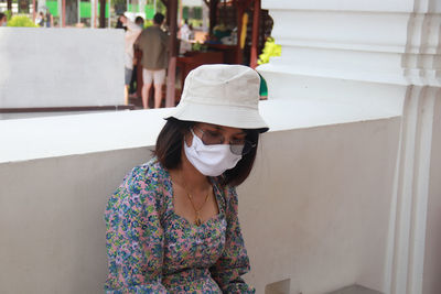 Full length of woman standing against white wall