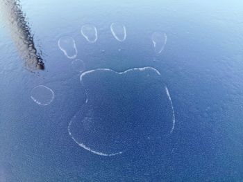 Close-up of heart shape on wet glass