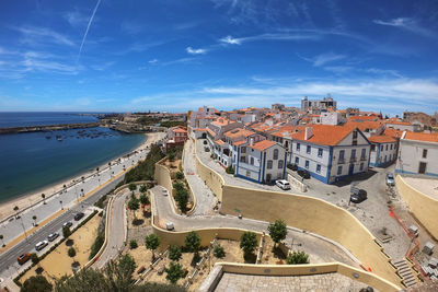 High angle view of road by buildings against sky