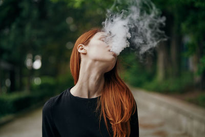 Young woman smoking cigarette