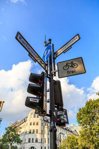 Low angle view of road sign against sky