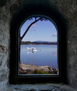 Scenic view of lake seen through window