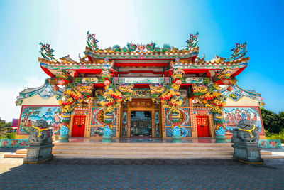 Statue outside temple building against sky