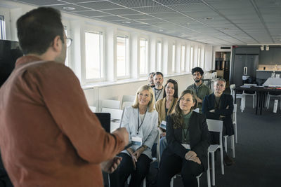 Group of business people attending presentation during conference