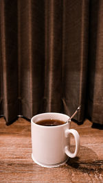 Close-up of coffee cup on table